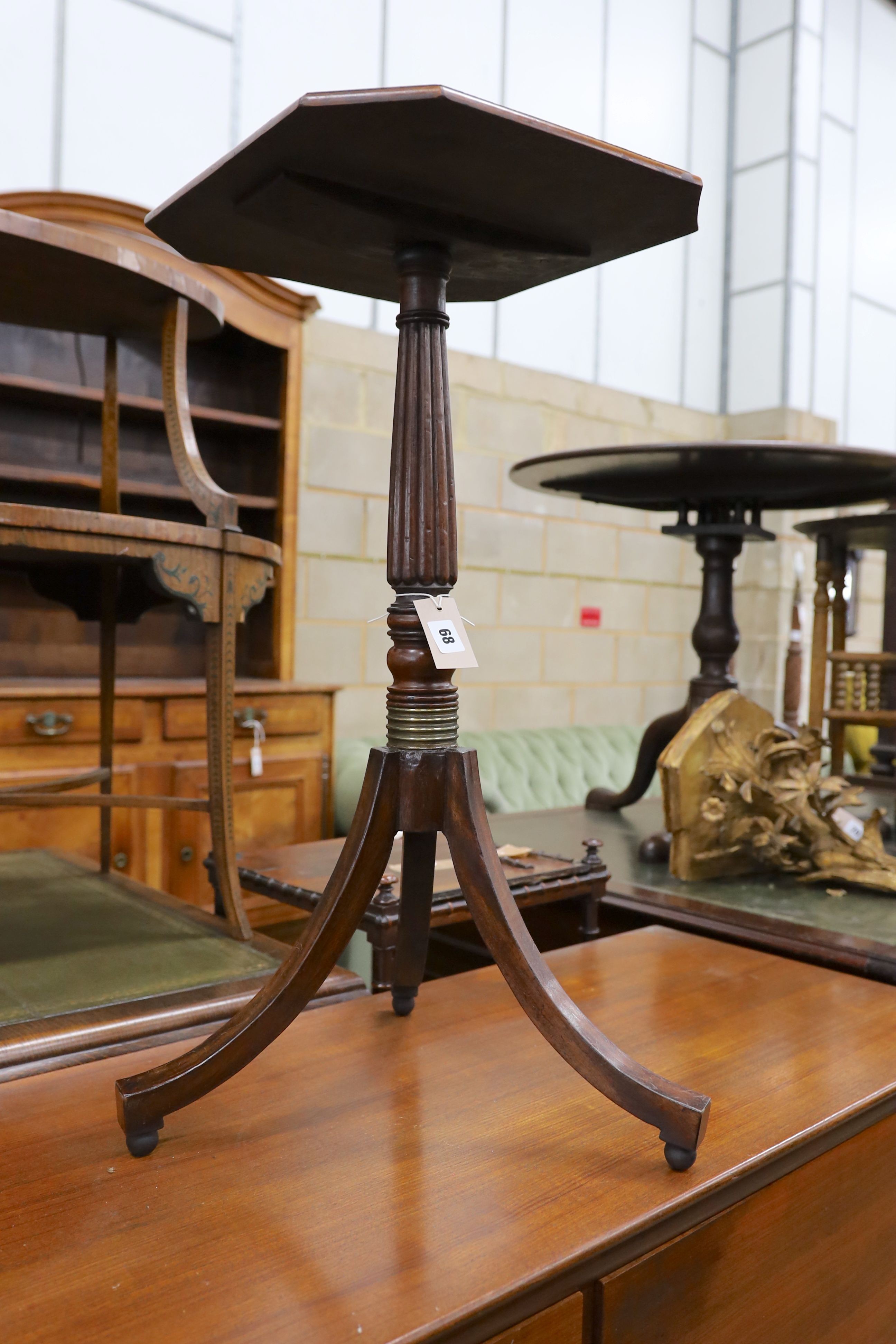 A pair of Regency style octagonal mahogany reeded column tripod wine tables, width 40cm, depth 36cm, height 75cm